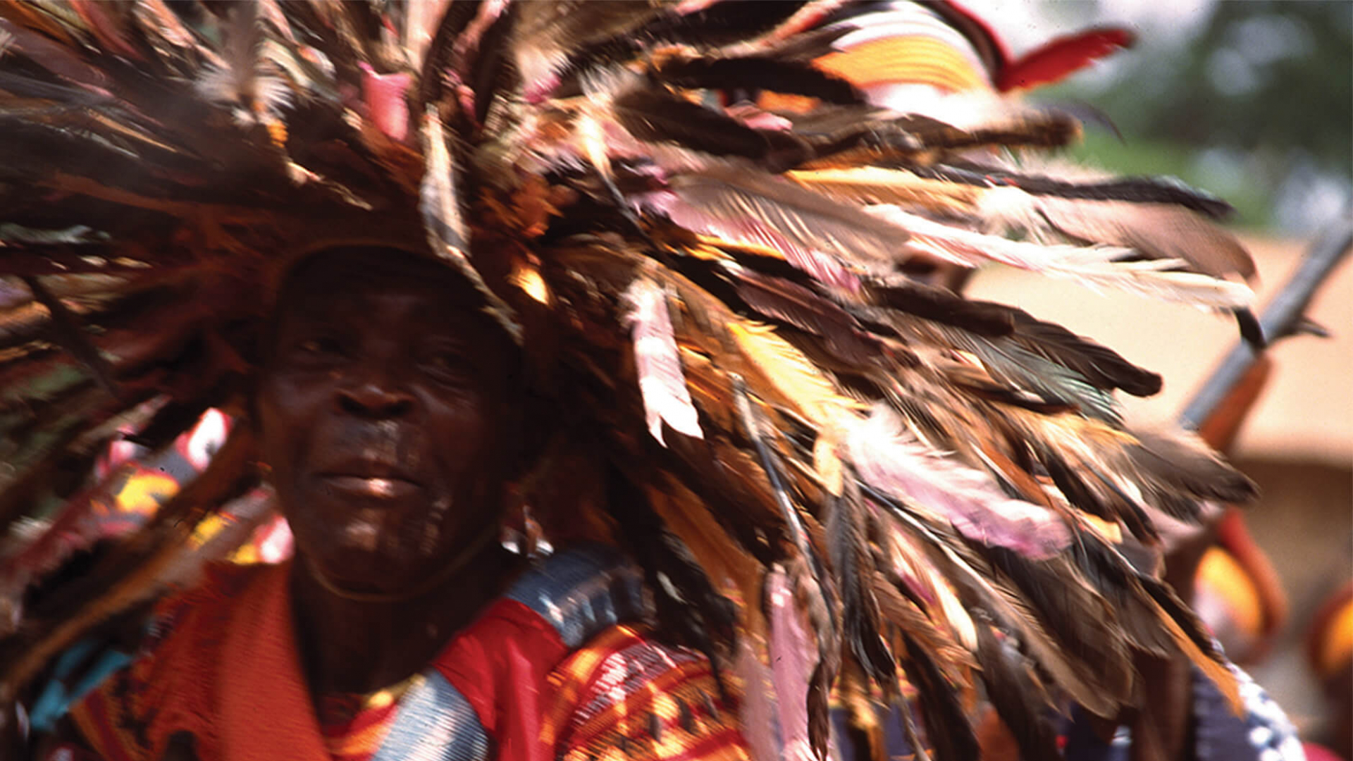 Ngumba elder with feather headdress.