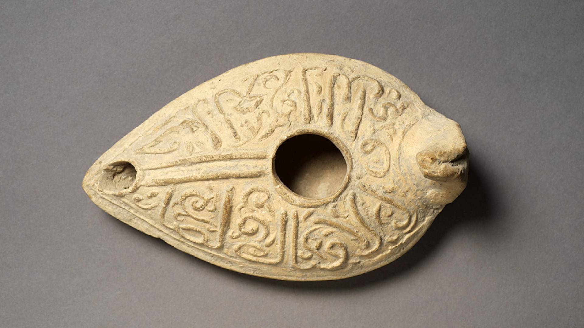 Oil lamp inscribed with good wishes to the owner in cursive Arabic.