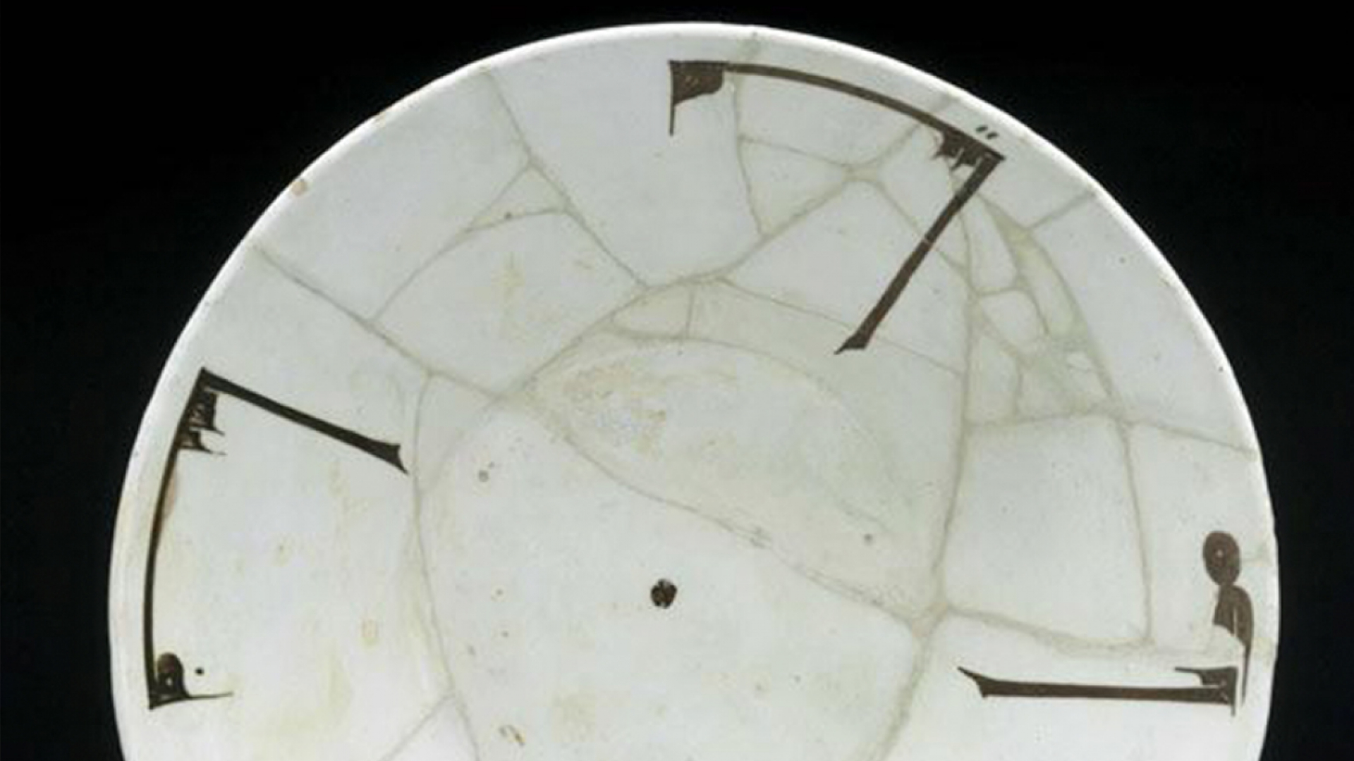 Slip-painted bowl with Kufic inscription.