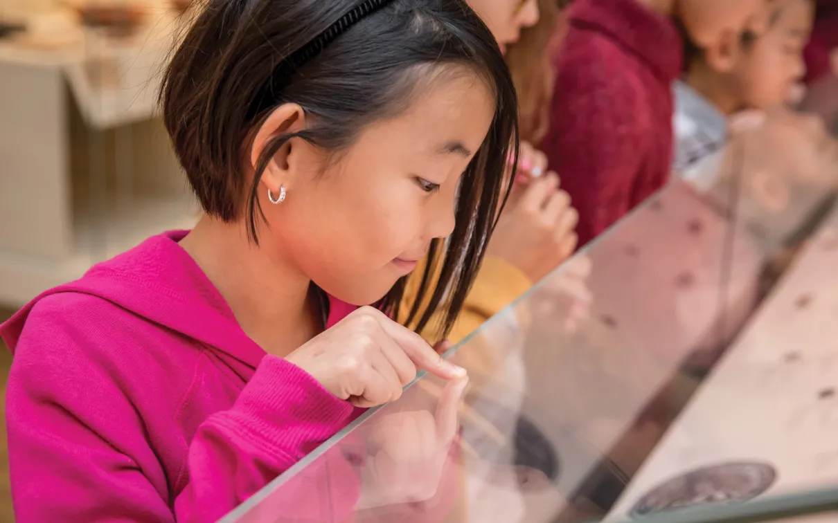 Student through glass display at ROM