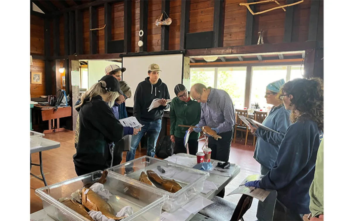 Group of people in the workshop gathered around table