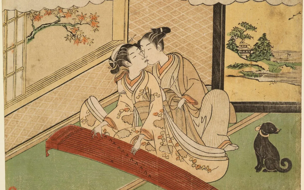 While playing koto a woman dressed in kimono turns her head to kiss a man crouched behind her.