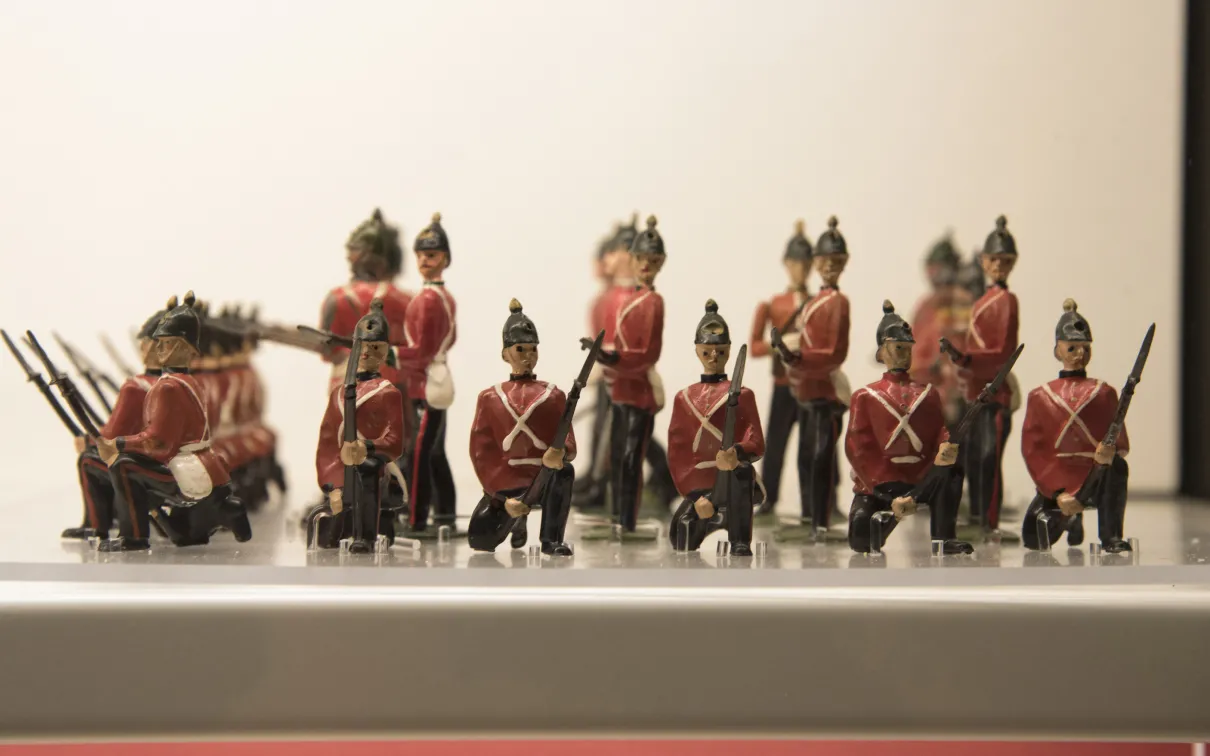 Close-up of a group of toy soldiers in red jackets standing in formation
