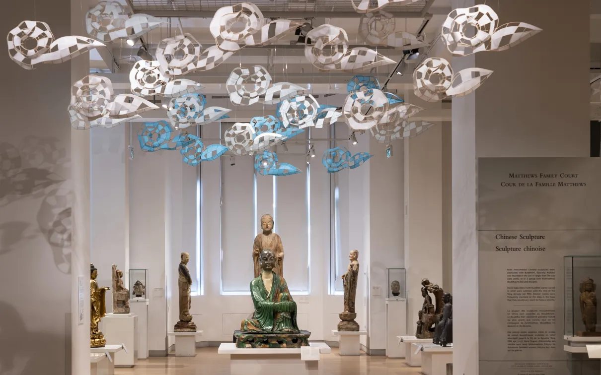 Paper clouds floating above Chinese statues