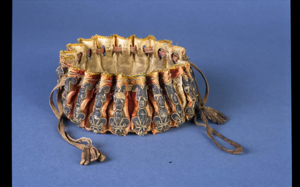 Alms purse. Perhaps made in France. 17th century. Silk velvet embroidered with silver filé laid over parchment. 930.13.3.