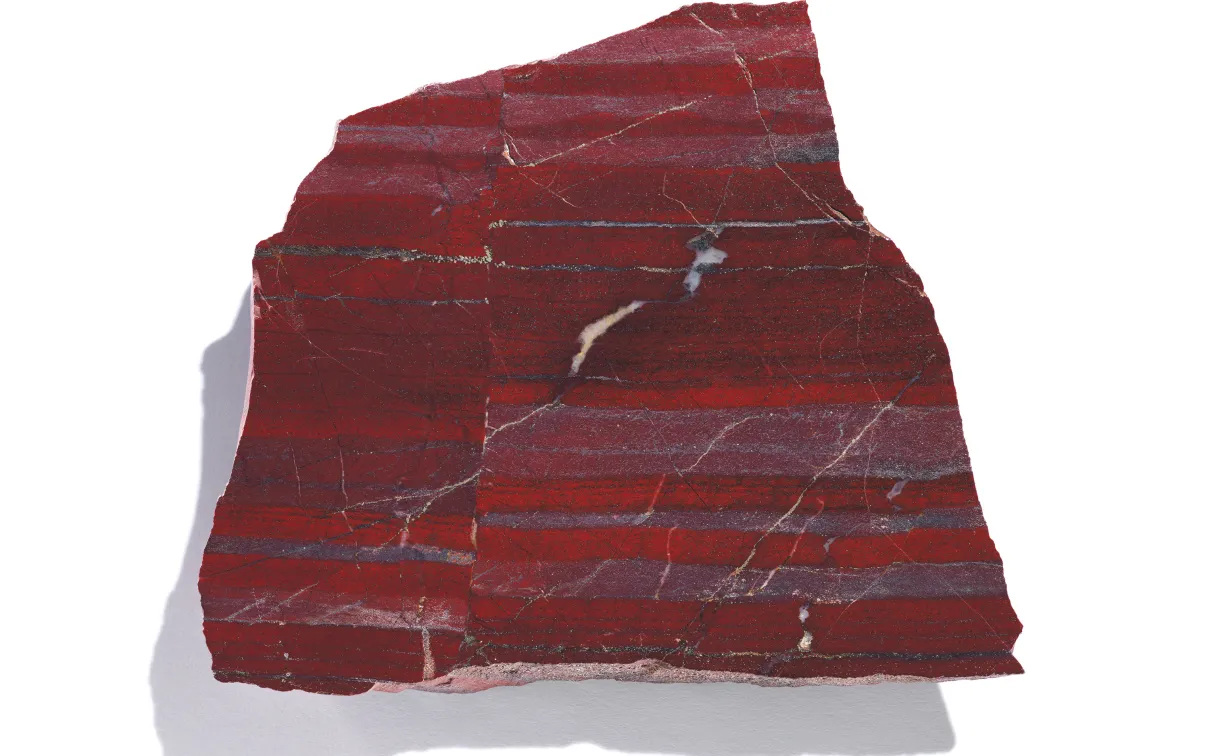 Slice of red banded mineral with shadow