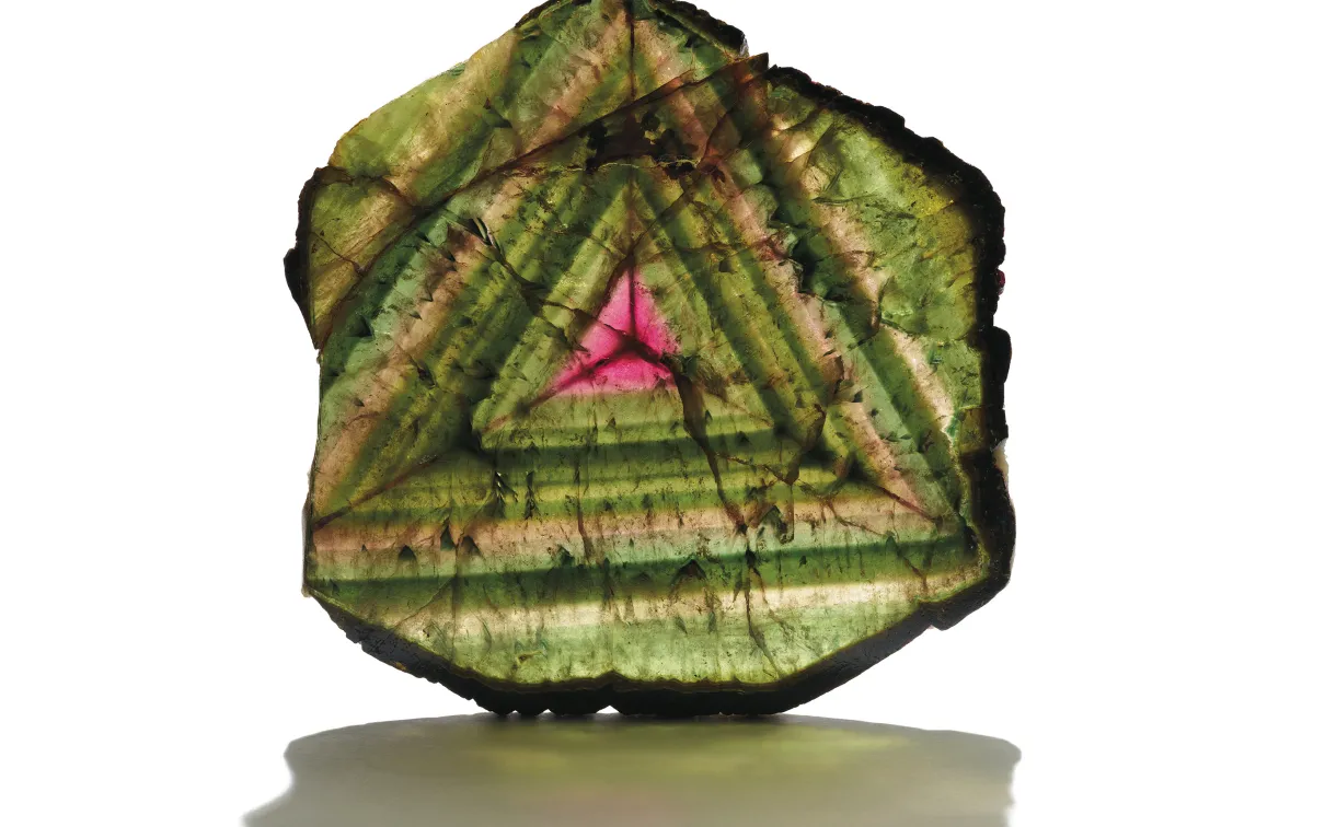 Slice of multi-coloutred mineral with shadow