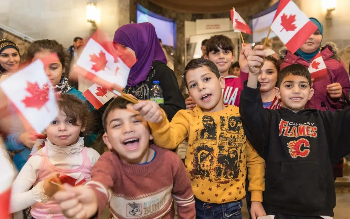 Kids waving Canadian flags