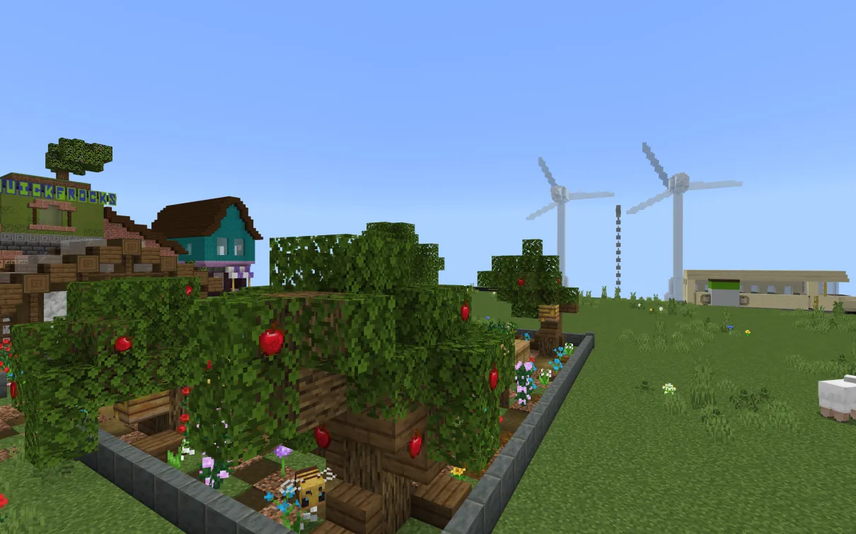 A minecraft screenshot of a community garden with trees and crops, showing windmills and an electric bus in the background.