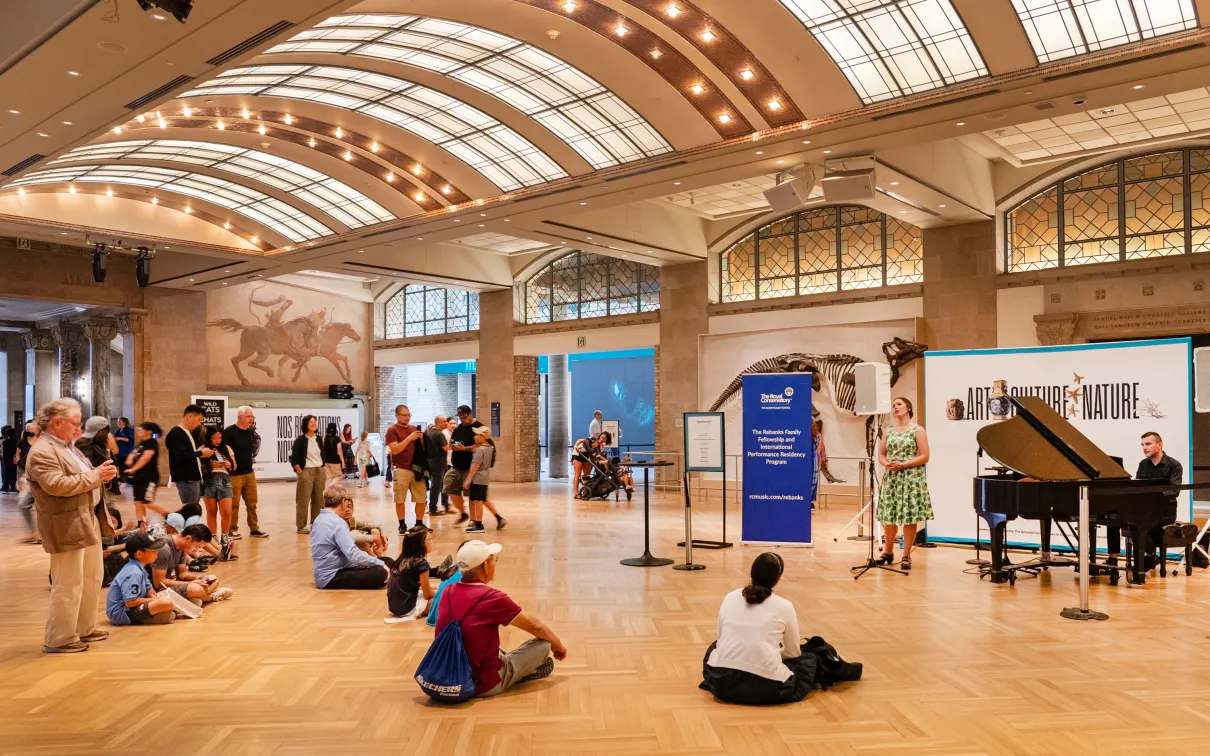 Gathering around a performance on the main floor at the Royal Ontario Museum. 