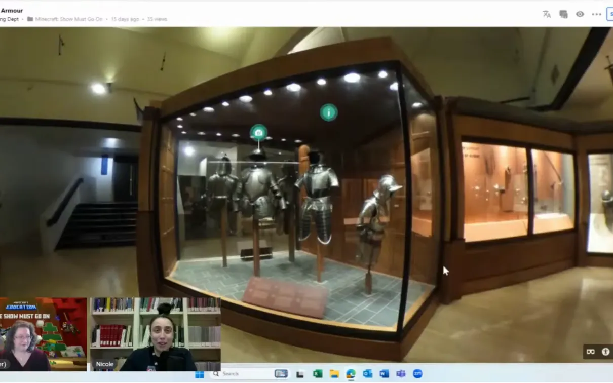 A screenshot of a lesson broadcast. in the bottom right corner are two female presenters. On the main screen is a 360 image of a gallery containing suits of armour.