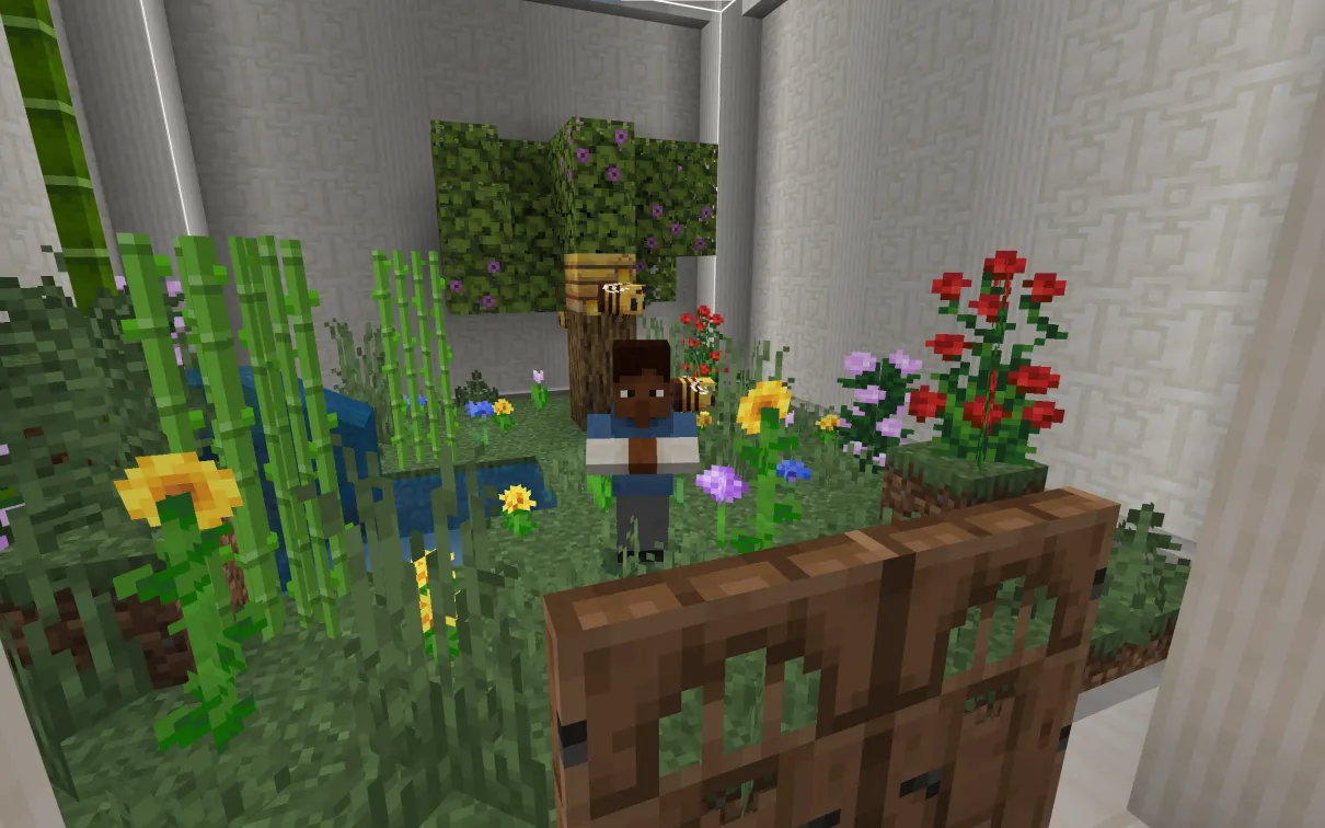 A Minecraft screenshot of a man standing in a lush garden with flowers and a beehive.
