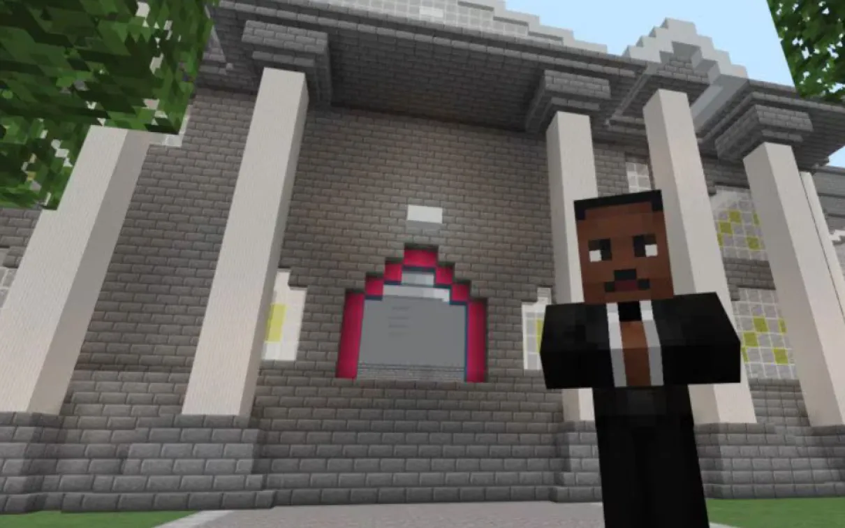 A Minecraft screenshot of a game character with dark skin and a suit standing in front of a large building with classical columns.