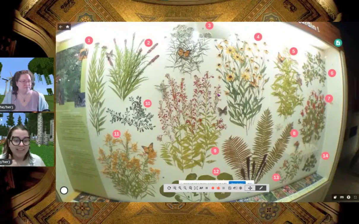 A museum display showing a variety of pressed flowers with numbers overlaid on top. On the left are two facecams of smiling women.
