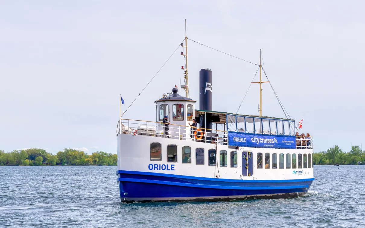 A tour boat on Lake Ontario with Toronto island in the background