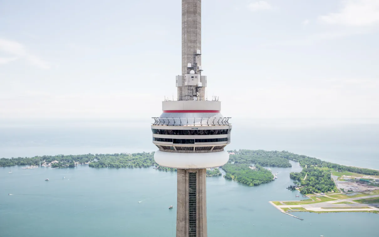 View of the top of the CN Tower with Lake Ontario and the city in the background