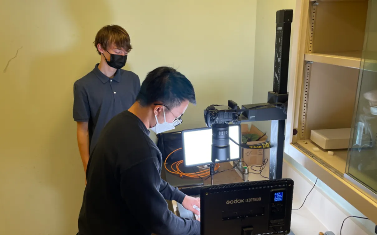Beckett Robertson and Colin Chiu, an entomology digitization technician, set up a specimens imaging station at ROM. (2023)