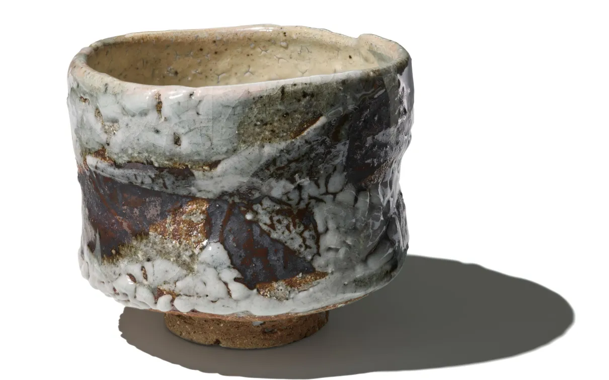 Image of a textured, glazed tea bowl by Japanese potter Ōmine Jissei
