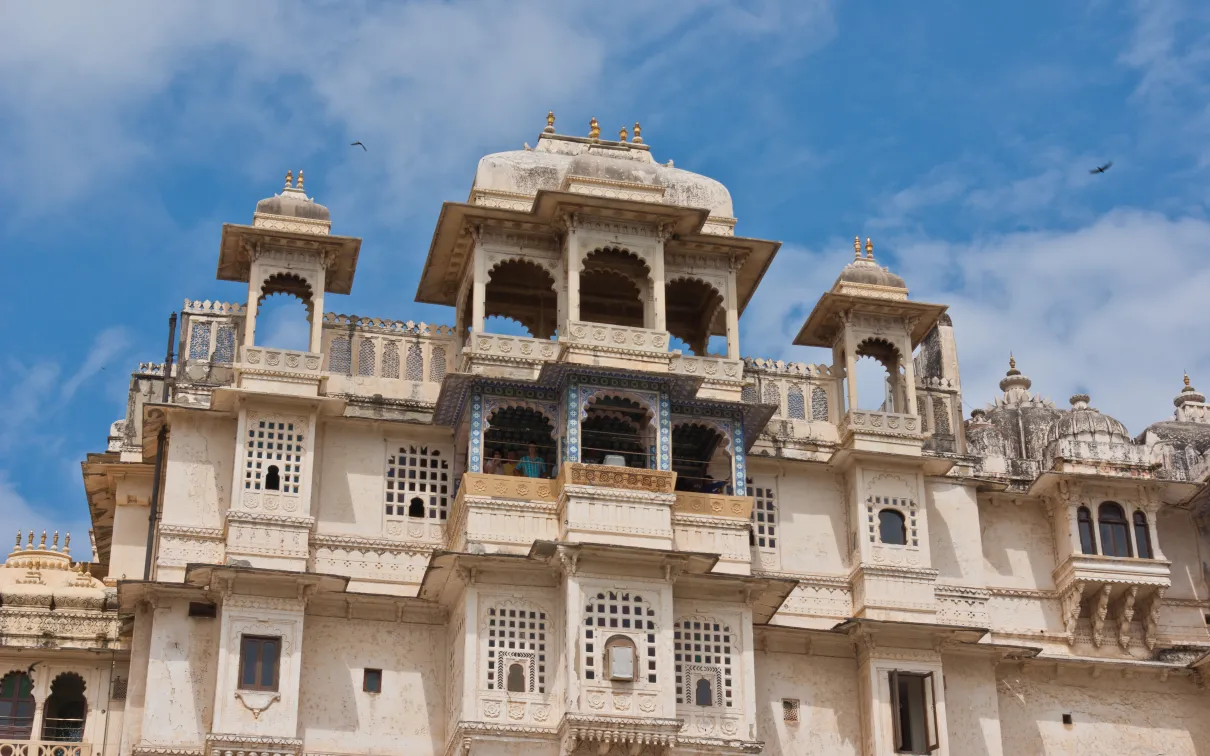 A white building with many windows against a blue sky