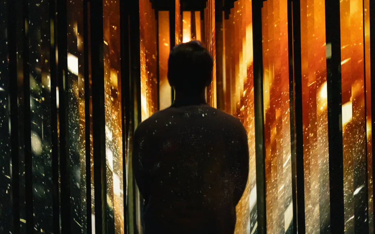 A person experiences an immersive activation in the exhibition.