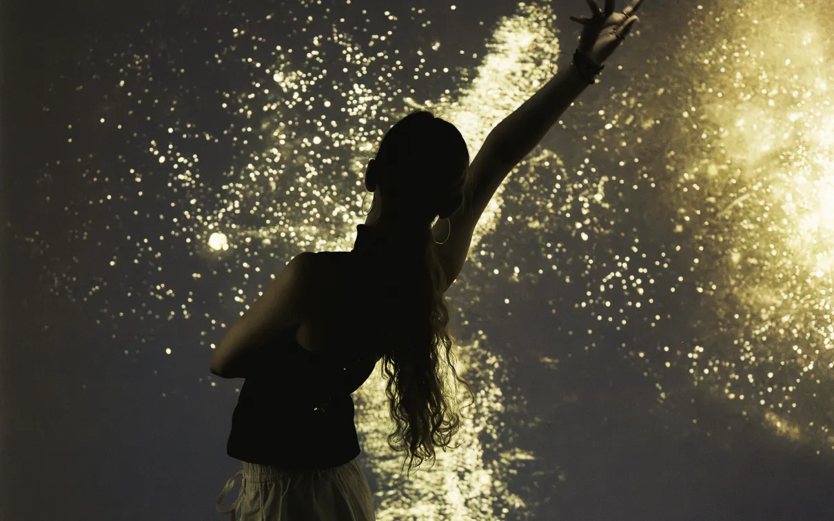 A person stands in front of an interactive pollen screen.