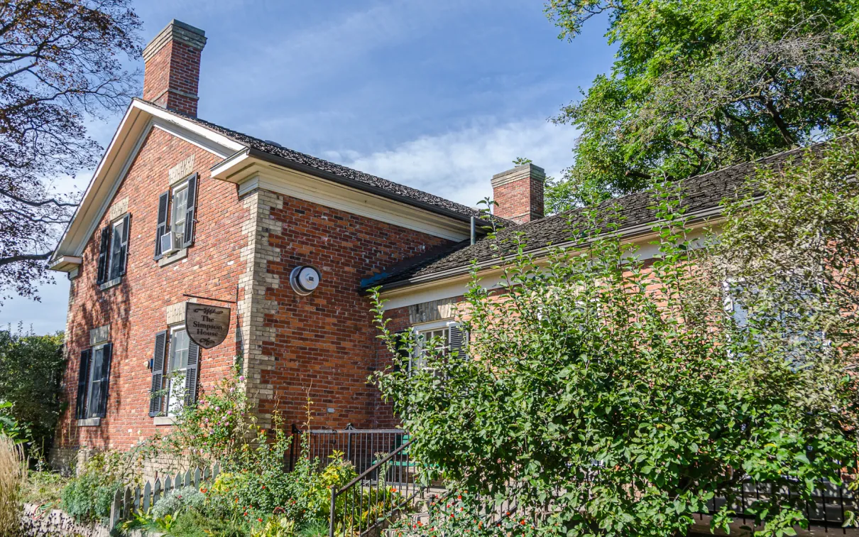 Front view of building on left with garden on the right