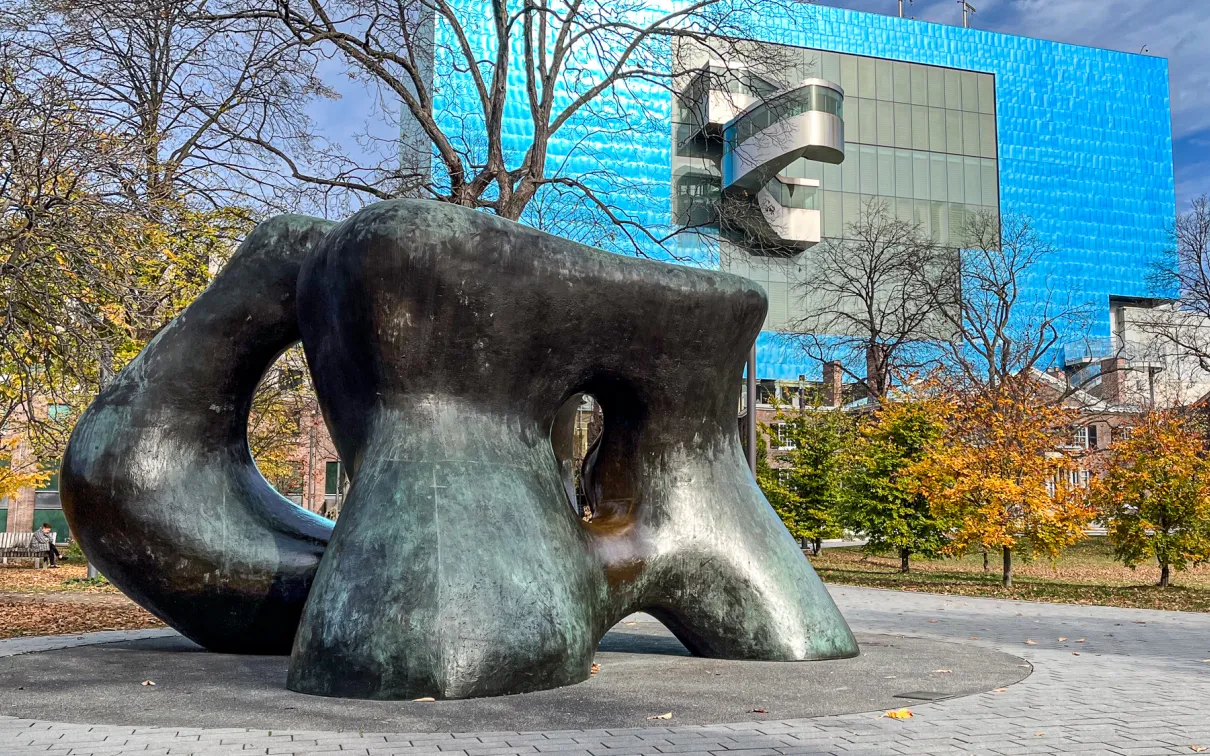 Large sculpture in foreground with building in background