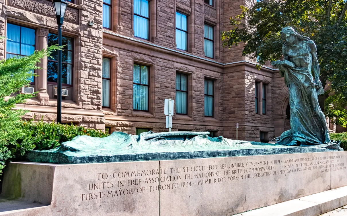 Memorial to Responsible Government in the foreground, with building in background