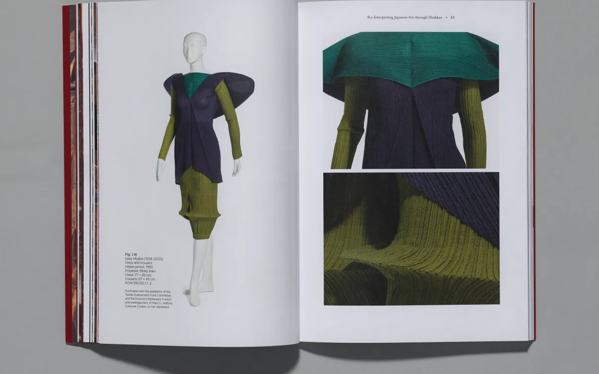 An open book spread featuring a textured, layered garment on a white mannequin, with close-up fabric details shown on the opposite page.