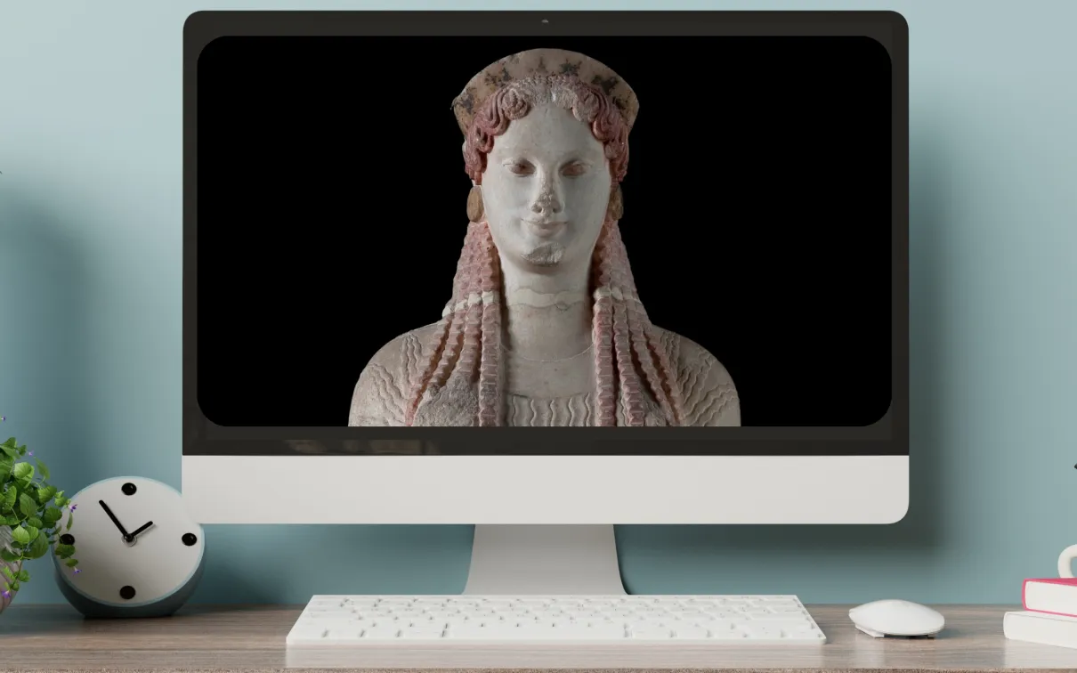 a monitor on a desktop displays an image of a greek statue