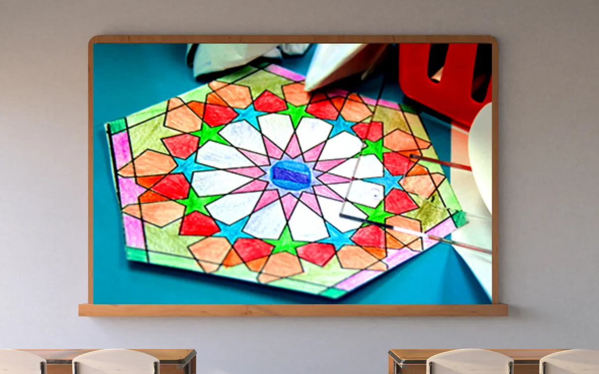 A screen on a classroom wall shows a colourful geometric pattern