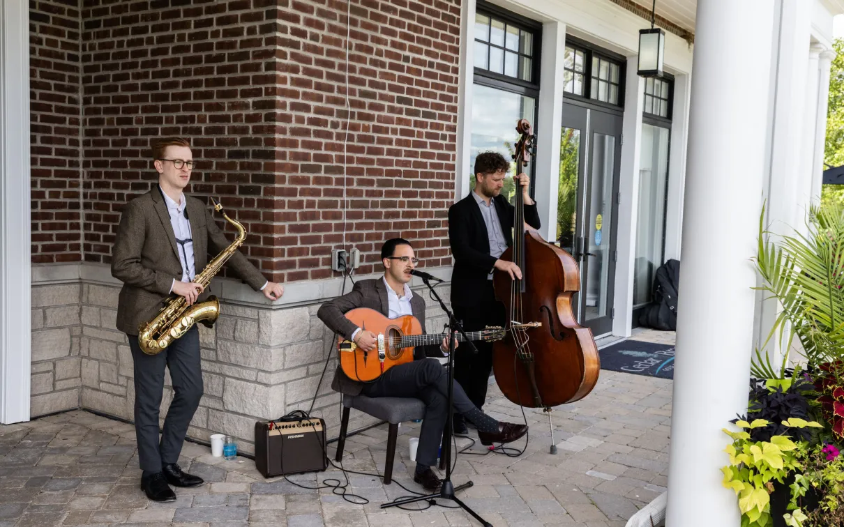 Three men musical trio playing at Cedar Brae golf club. 