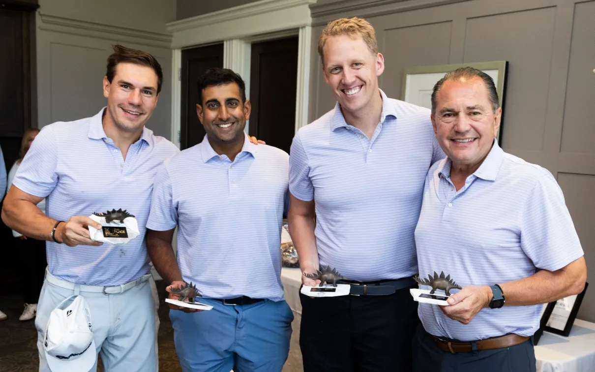 4 men holding the 2nd place foursome trophies. 