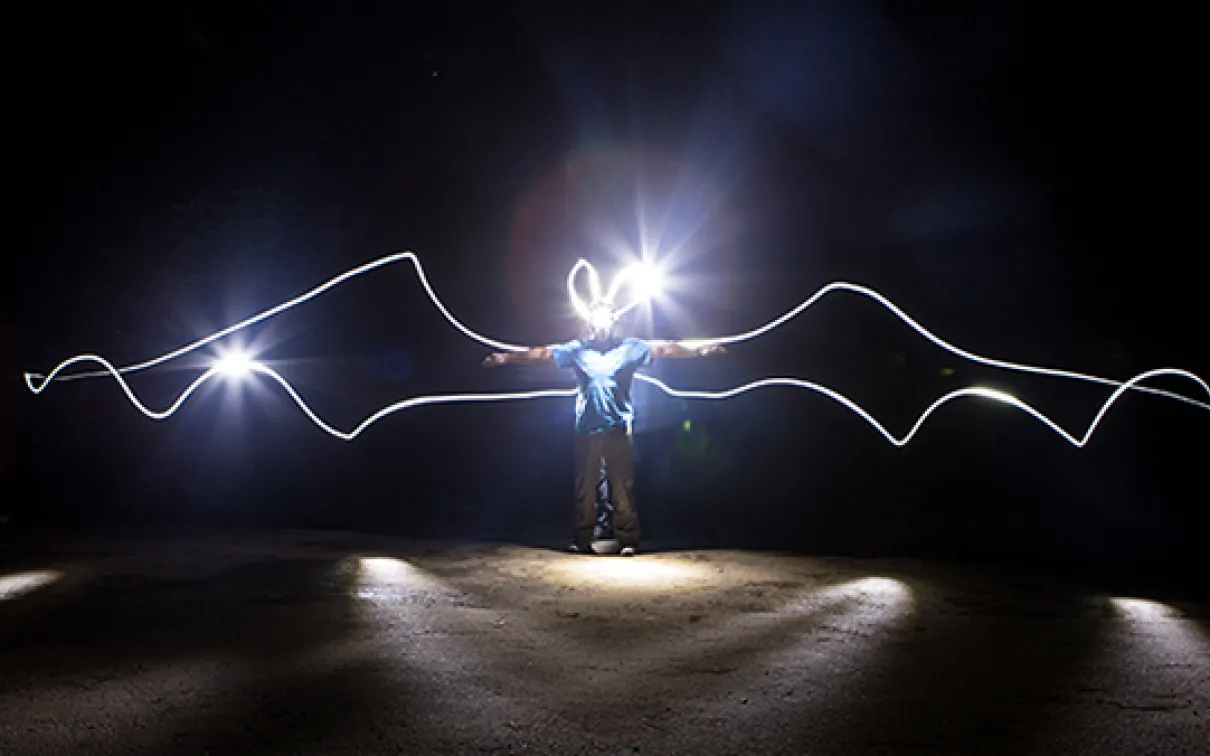 The ROM’s very own ‘Batman’, Assistant Curator of Mammalogy, Dr. Burton Lim with "bat wings" outlined with light in a long exposure photo. Credit: Vincent Luk
