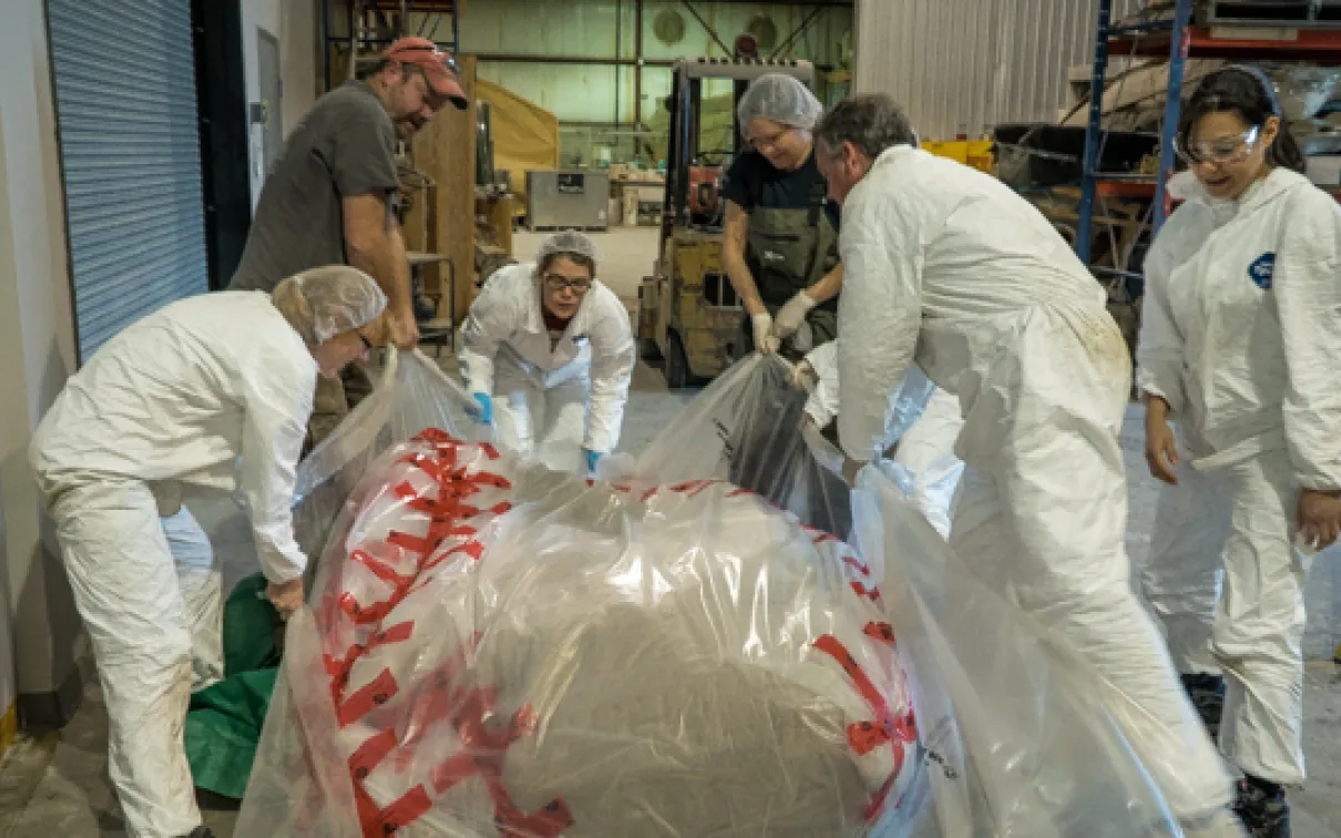 It took a team of seven people to lift the blue whale heart enough to finish wrapping it. Photo by Stacey Lee Kerr
