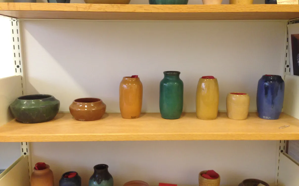 Detail of ceramic vessels on shelf
