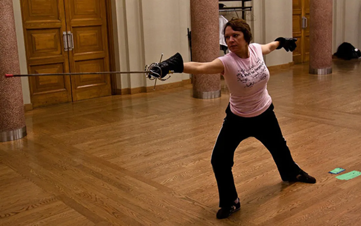 ROM Mammalogy technician Jacqueline Miller with sword in hand in a fencing match - always up for a challenge. Photo credit Jacqueline Miller
