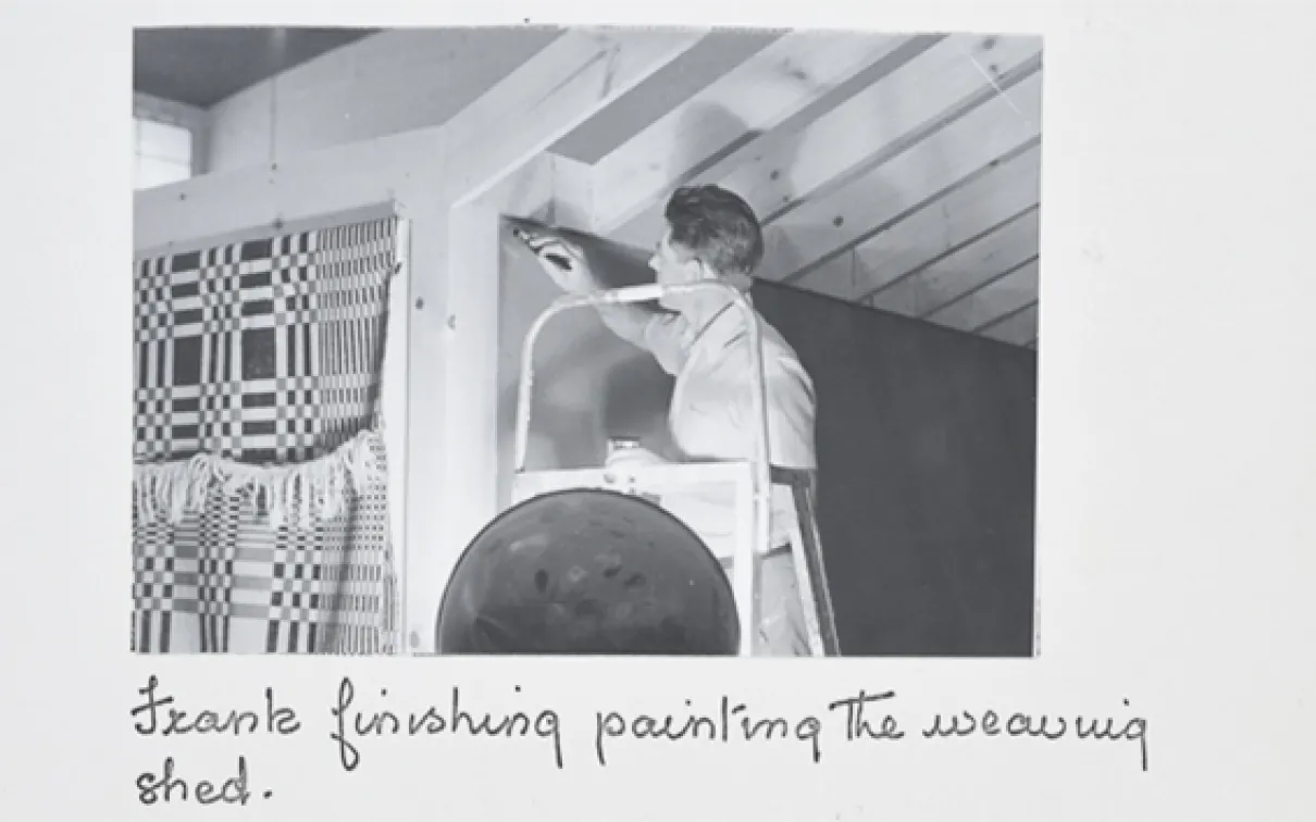 "Frank finishing painting the weaving shed."

