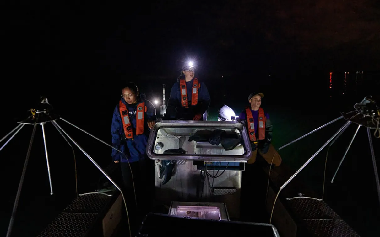 A team drives the electrofishing boat