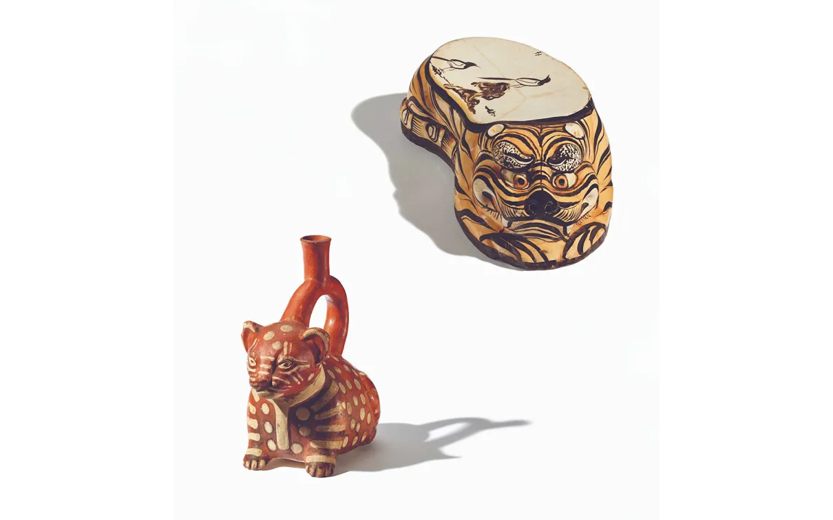 Photos of a pillow in tiger form and a stirrup spout vessel in the form of a seated cat.