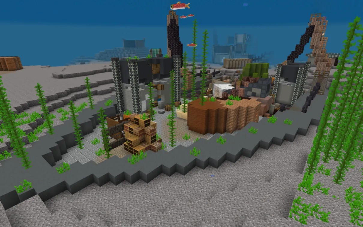 Capture d'écran Minecraft d'un cargo coulé avec des poissons nageant autour des bras de grue et des conteneurs brisés.

