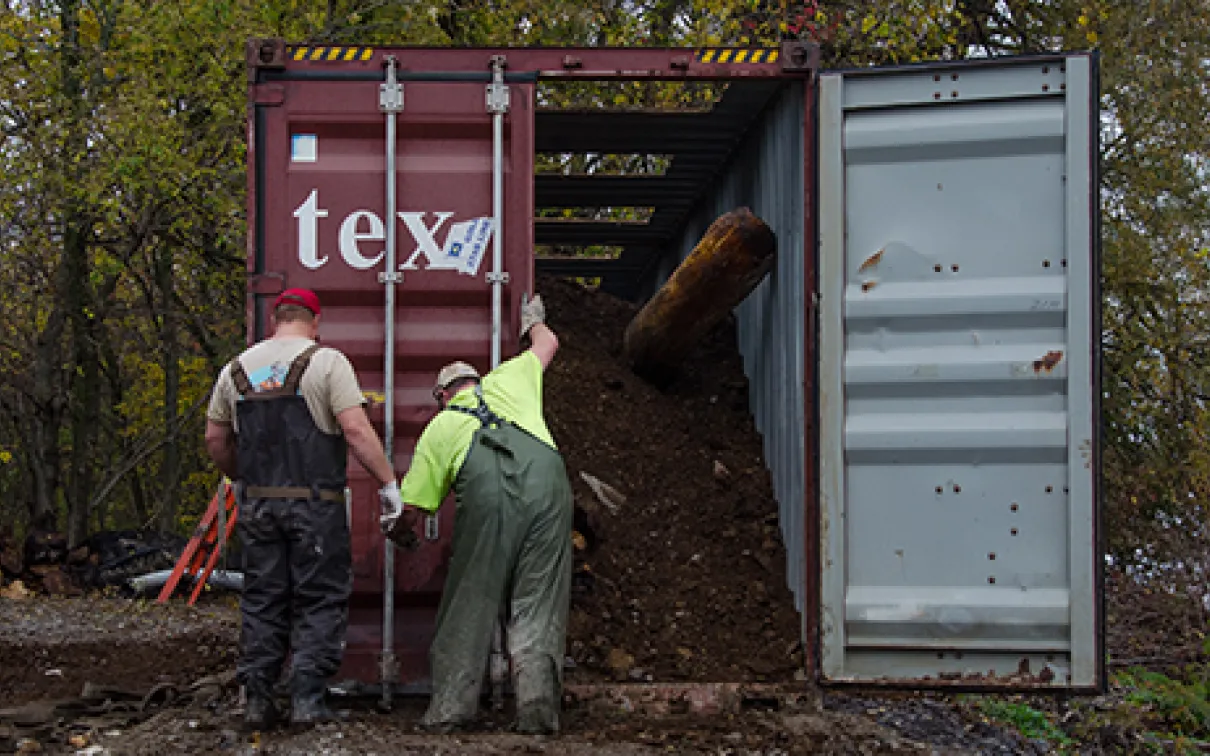Blue whale with workers on the coast

