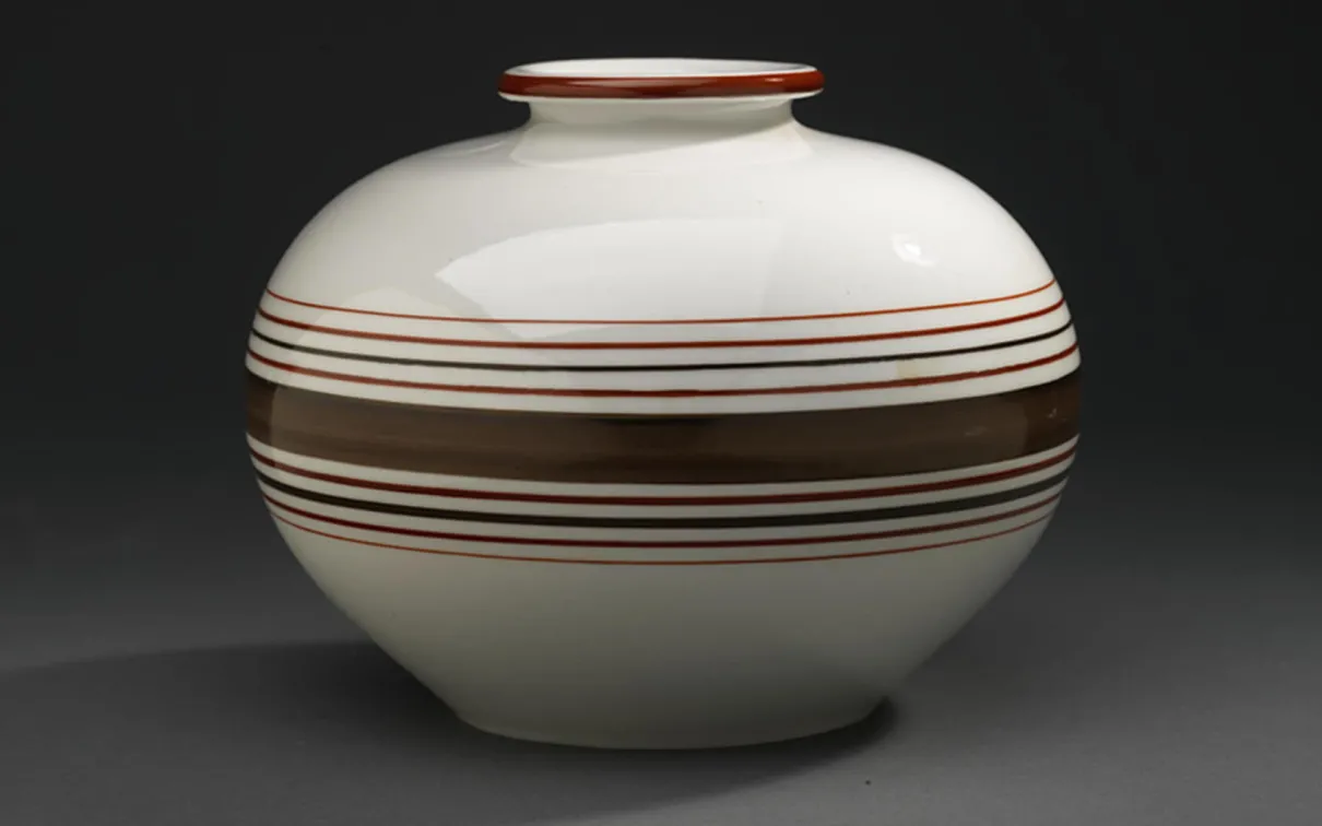 A porcelain vase with brown stripes.