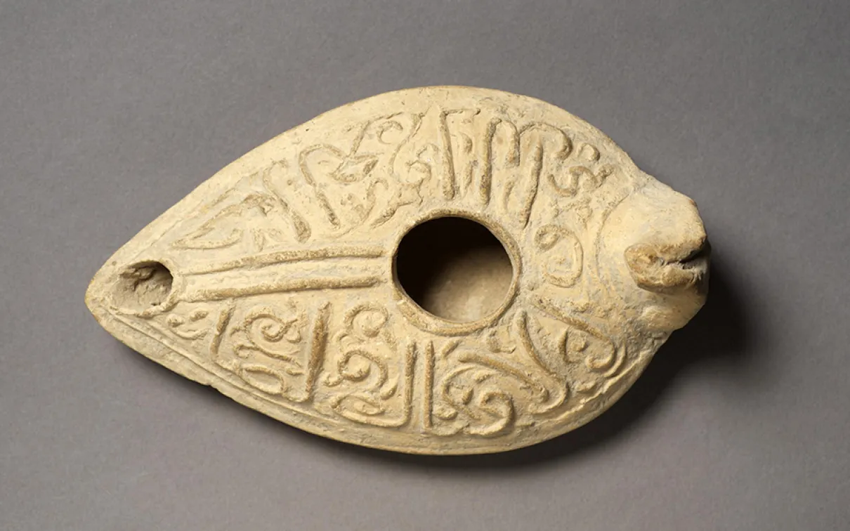 Oil lamp inscribed with good wishes to the owner in cursive Arabic.