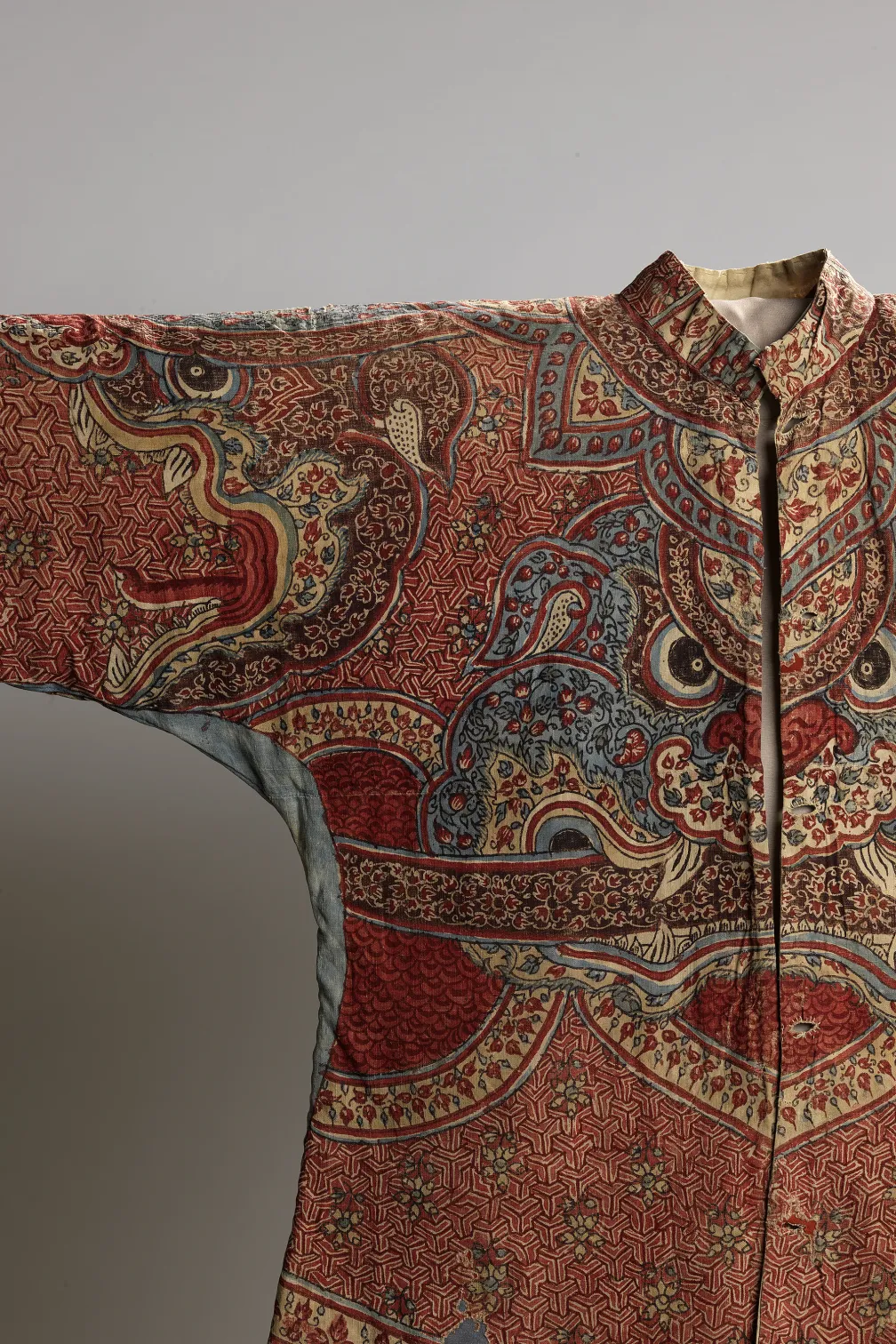 A beautifully designed oriental jacket adorned with a dragon motif on the front, reflecting traditional craftsmanship and artistry.