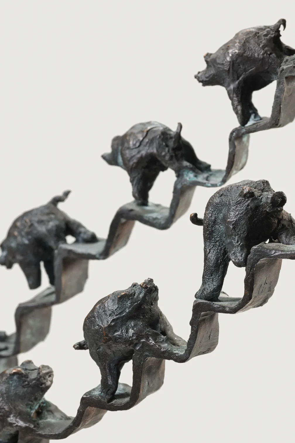 Sculpture of pigs walking up and down a staircase 