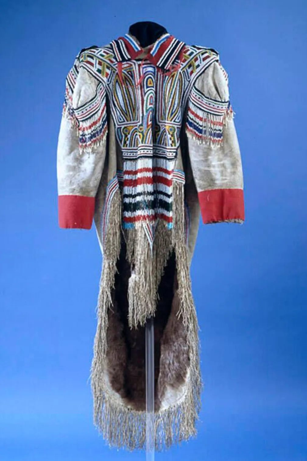 A grey caribou skin parka decorated with intricate red, black, white, and blue designs made from beads.