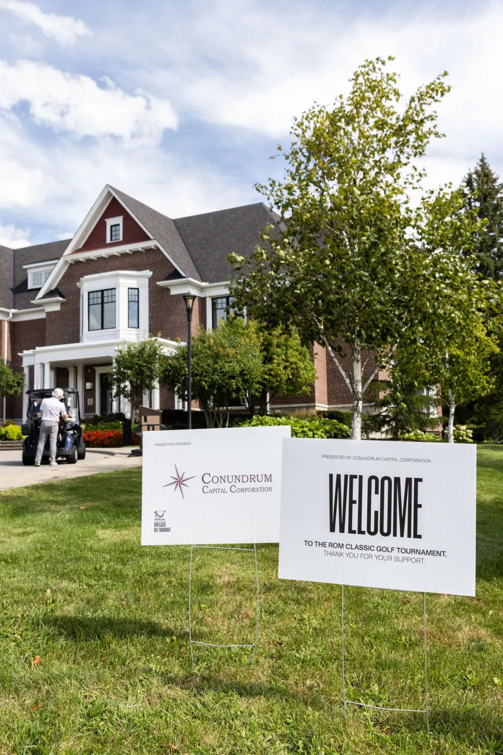 Cedar Brae clubhouse with our Welcome sign and Presenting Sponsor Conundrum Capital Corporation. 