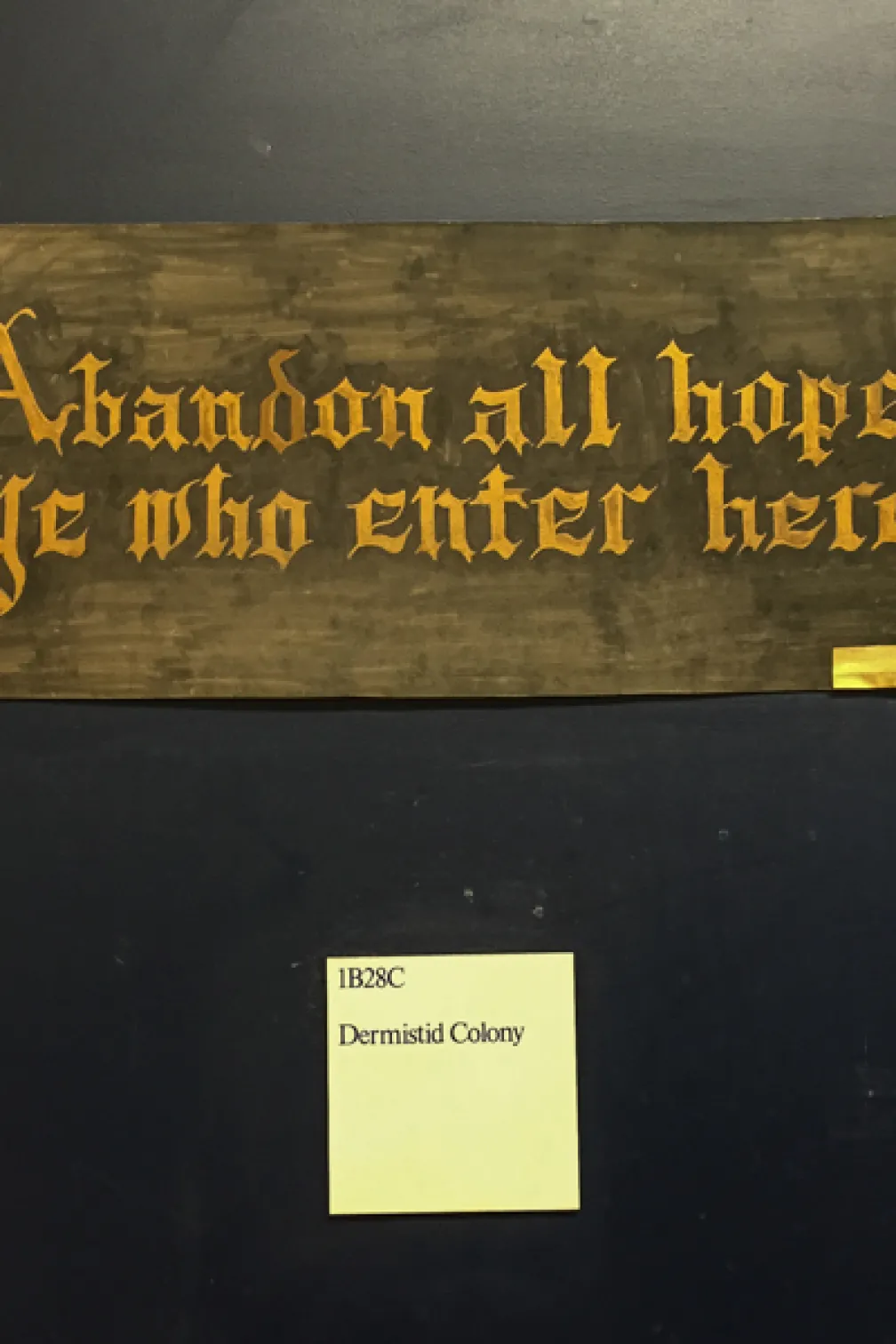 A photo of the sign posted outside the door of the ROM's dermestid beetle colony quotes Dante's Inferno, "Abandon all hope ye who enter here"
