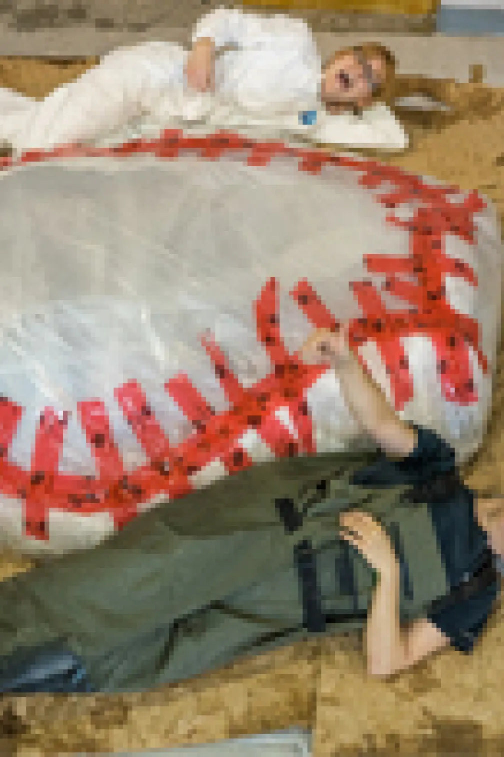 ROM research technician Jacqueline Miller and Schad Gallery Coordinator Nicole Richards pose with the wrapped blue whale heart for scale.
